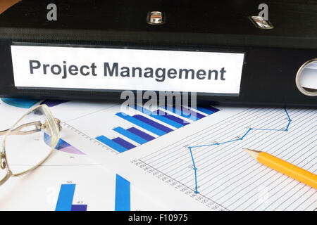 Graphs and file folder with label  Project Management. Business concept. Stock Photo