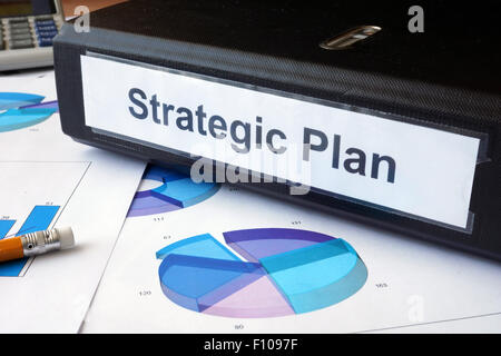 Graphs and file folder with label Strategic plan. Business concept. Stock Photo