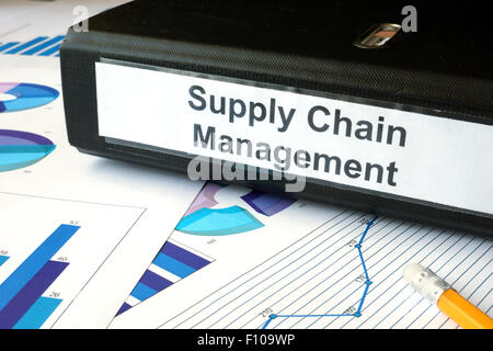 Graphs and file folder with label supply chain managment. Business concept. Stock Photo