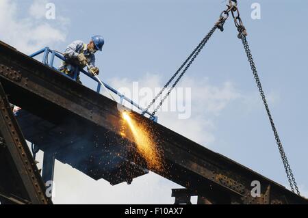 demolition of an old railway iron bridge with plasma cutting flame (Milan, Italy) Stock Photo
