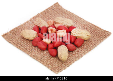 Fresh Peanuts in sack over white background Stock Photo