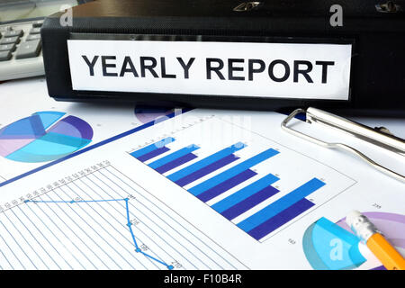 Folder with the label yearly report and charts. Stock Photo