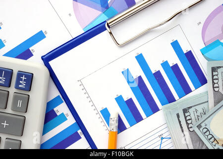 Papers with graphs, calculator and dollars. Finance concept. Stock Photo