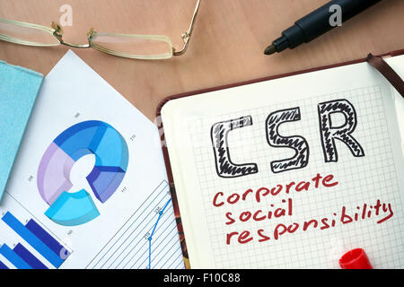 Notepad with word CSR corporate social responsibility concept and marker. Stock Photo