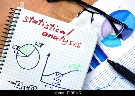 Notepad with words statistical analysis  on a wooden background Stock Photo