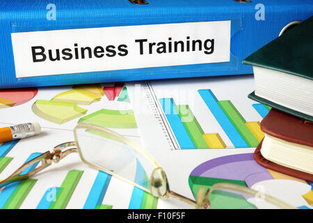 Folder with label Business Training and charts. Stock Photo