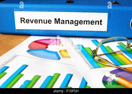 Folder with label  Revenue Management and charts. Stock Photo