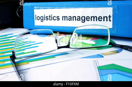 Folder with label logistics management on the office table. Stock Photo