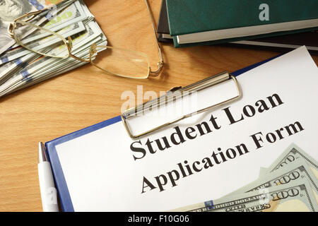 Student loan form with dollars and books. Stock Photo
