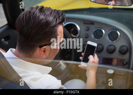 Driver man using smartphone in car Stock Photo