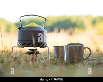 Making camping coffee from a geyser coffee maker on a gas burner,, autumn  outdoor. Male prepares coffee outdoors, travel activity for relaxing,  bushcr Stock Photo - Alamy