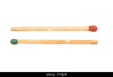 Green and red wooden matches lying in opposite directions, isolated on white background Stock Photo