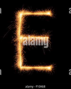 'E' letter drawn with bengali sparkles isolated on black background Stock Photo