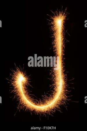 'J' letter drawn with bengali sparkles isolated on black background Stock Photo