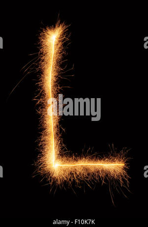 'L' letter drawn with bengali sparkles isolated on black background Stock Photo