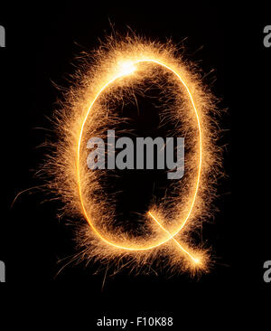 'Q' letter drawn with bengali sparkles isolated on black background Stock Photo