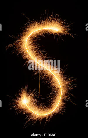 'S' letter drawn with bengali sparkles isolated on black background Stock Photo