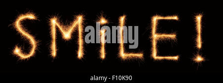 "Smile!" lettering drawn with bengali sparkles isolated on black background Stock Photo