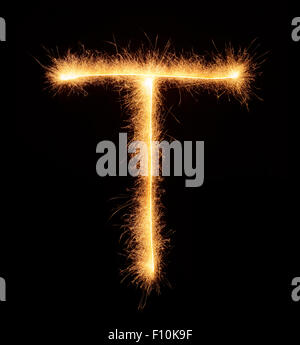 'T' letter drawn with bengali sparkles isolated on black background Stock Photo