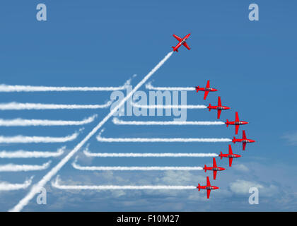 Game changer business or political change concept and disruptive innovation symbol and be an independent thinker with new industry ideas as an individual jet breaking through a group of airplane smoke as a metaphor for defiant leadership. Stock Photo
