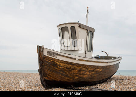 A fishing boat beached at Deal in Kent with the North Sea in the background Stock Photo