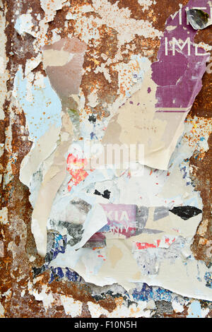 Peeling old decayed billboard posters - lots of layers of advertising ...