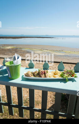 A view across the bay at low tide from a table at the Beach Hut cafe and restauarant on the beach at Bembridge Isle of Wight Stock Photo