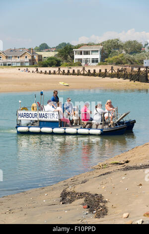 Passengers on a small ferry called Harbourmaster 2 at Bembridge on the Isle of Wight Stock Photo