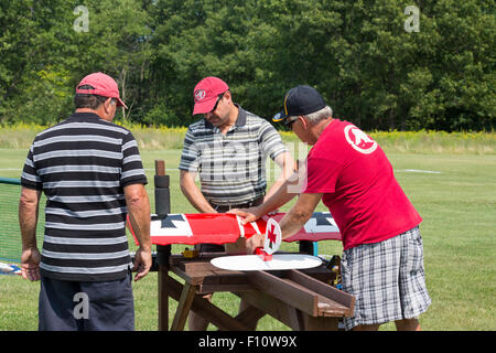 White Lake, Michigan - Members of the Pontiac Miniature Aircraft Club prepare a remote controlled airplanes for flight. Stock Photo