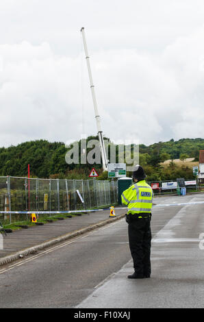 Shoreham-by-Sea, UK. 24th August 2015. The scenes in Shoreham-by-Sea, West Sussex, where a Hawker Hunter jet crashed into vehicles on the A27 and exploded during the Shoreham Air Show on Saturday 22nd August 2015. A crane has been brought to the site to remove the remains of the jet for further investigation. Many people have left floral tributes and football memorabilia on the Old Shoreham Tollbridge, close to the scene of the accident, for those that have died. Police say up to 20 people may have died in the incident. Credit:  Francesca Moore/Alamy Live News Stock Photo