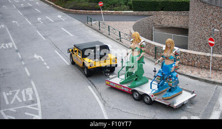 Battling robots being towed by a Hummer touring the streets of Shinjuku, Tokyo, Japan. Stock Photo