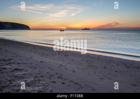 boats on horizon in bay for sunrise in summer Stock Photo