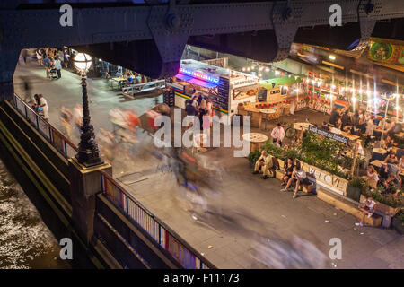 The South Bank at night, under Hungerford / Golden Jubilee Bridge, London, UK Stock Photo