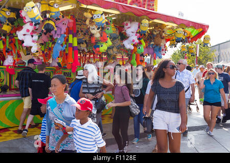 People walking past the Whack A Mole game at the Canadian National Exhibition in Toronto, Ontario Canada Stock Photo