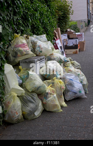 Polythene bags of rubbish on street awaiting collection for recycling Germany Stock Photo