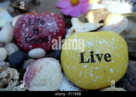 Inspirational quotes on garden rocks. Stock Photo