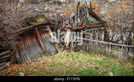 Old ruined village wooden house in autumn Stock Photo