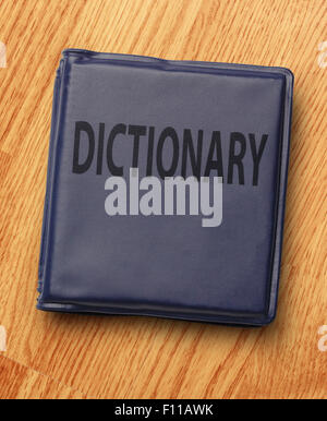 Dark blue dictionary on the wooden background Stock Photo