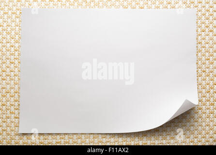 Blank sheet of paper on white fabric background Stock Photo