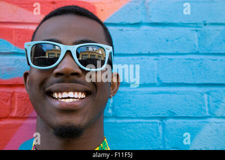 Close up of Black man wearing colorful sunglasses Stock Photo