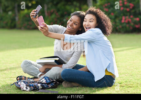 Black women taking selfies in park Stock Photo