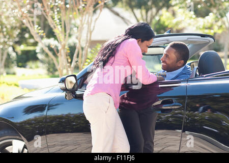 Couple hugging in convertible Stock Photo