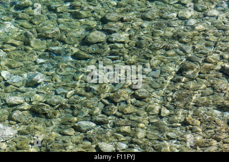 Stones on the seabed with sun reflection, island Corfu, Ionian Islands, Greece Stock Photo