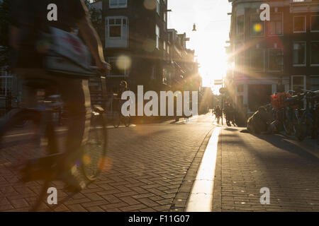Blurred view of bicyclist on city street Stock Photo