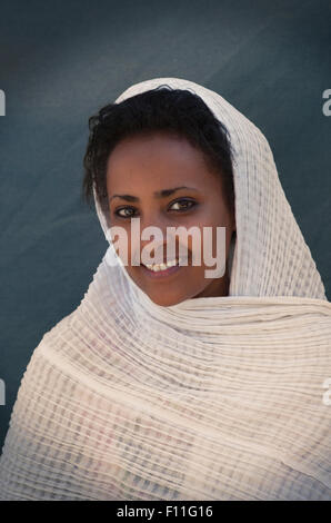 Smiling Black woman wrapped in scarf Stock Photo
