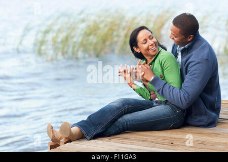 Smiling couple hugging at dock Stock Photo