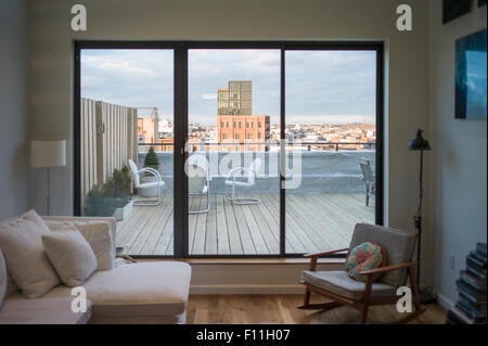 Modern living room and patio on urban rooftop, New York, New York, United States Stock Photo