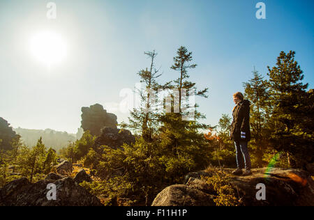 Caucasian hiker admiring view from remote hilltop Stock Photo