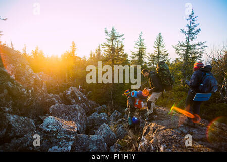 Caucasian hikers walking on remote mountainsides Stock Photo