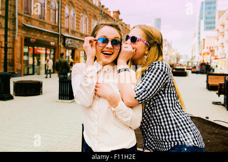 Women making faces in city Stock Photo